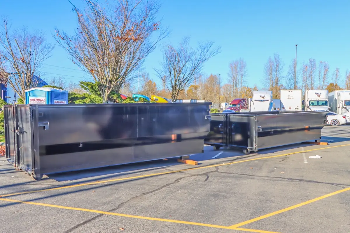 Professional dumpster rental service with roll-off container on residential driveway in Downey